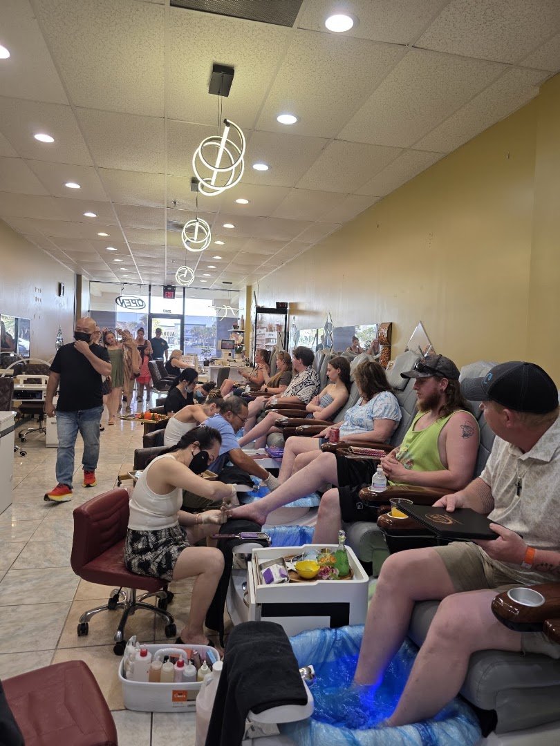 Nail salon stations with polish bottles and manicure tools.