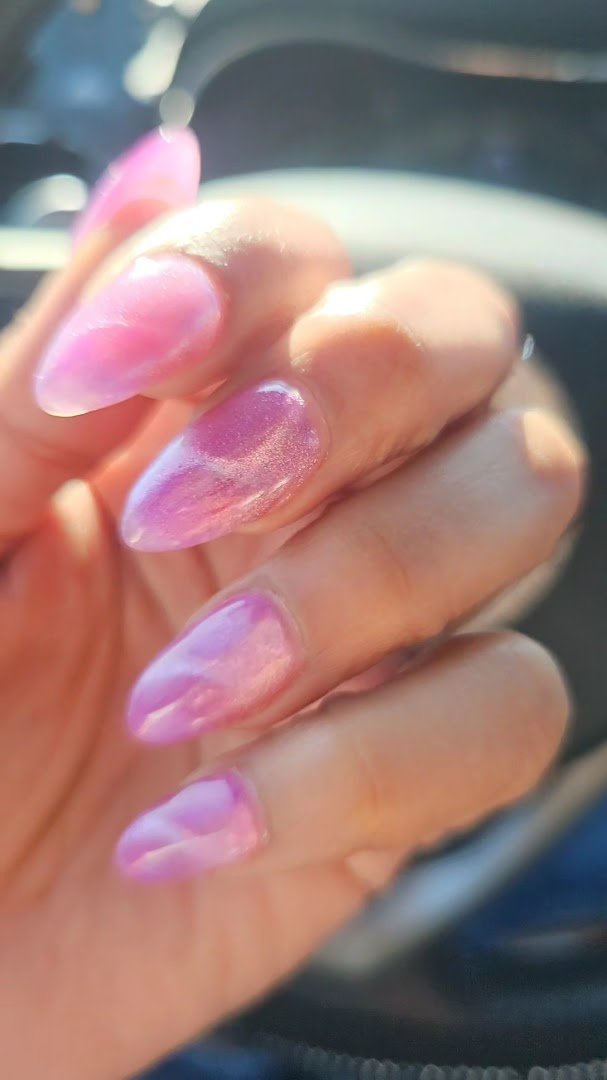 Nail salon stations with polish bottles and manicure tools.